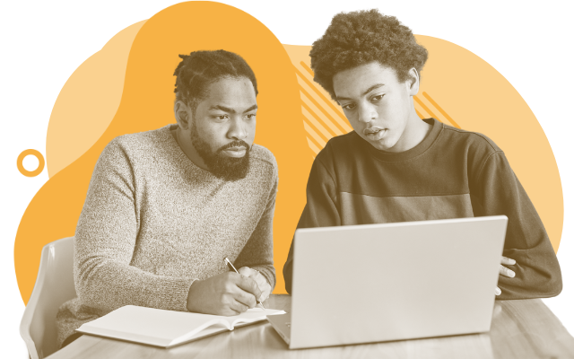 Father and son looking at a computer and taking notes